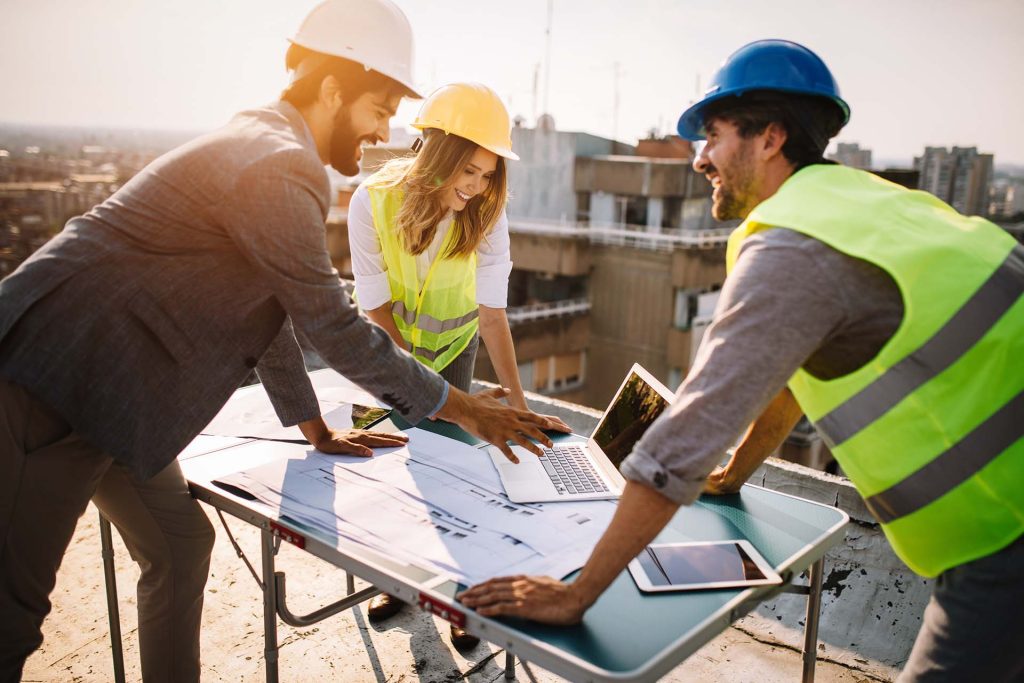 Architects, business manager and engineer meeting project at building site